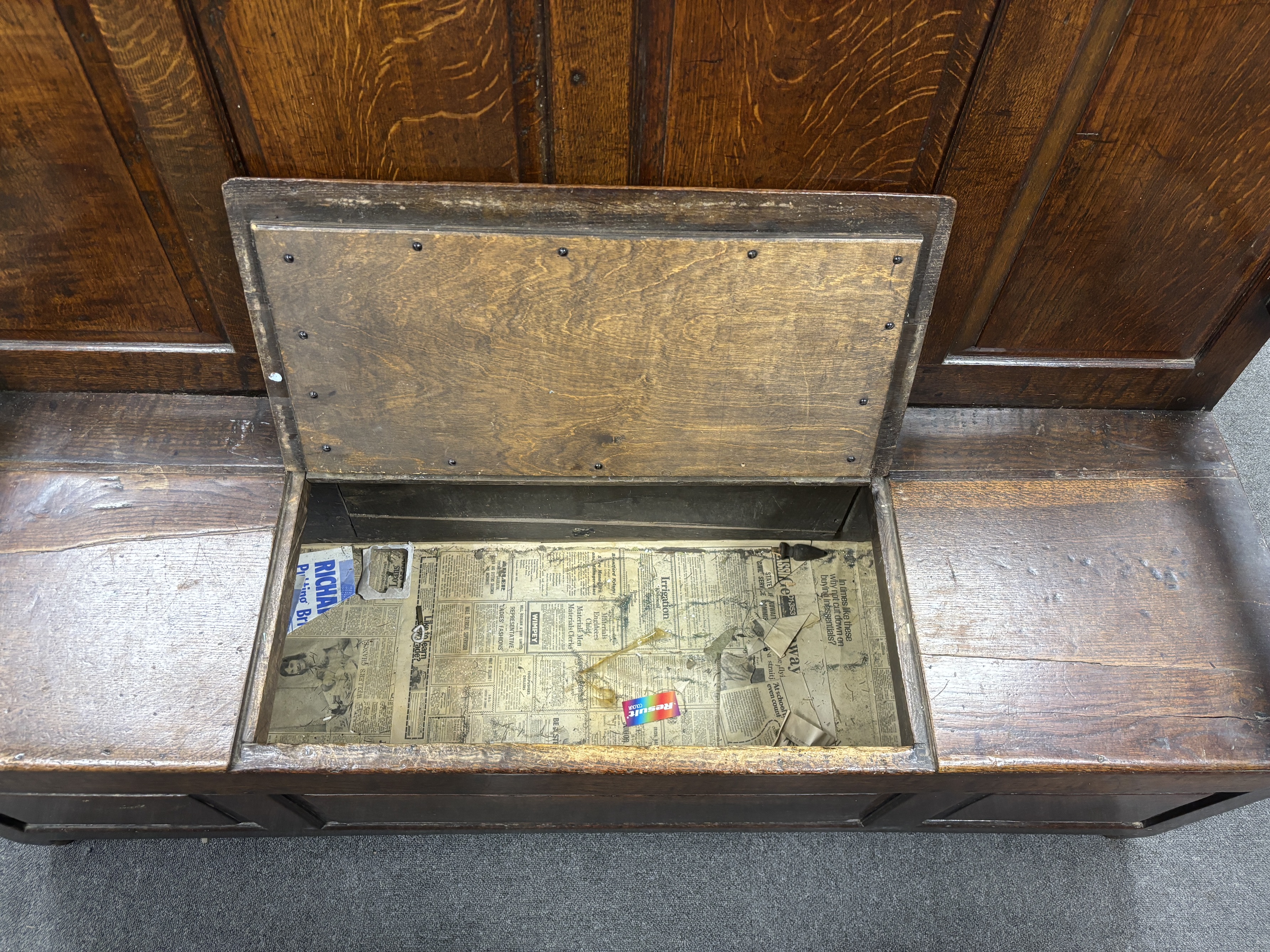 An 18th century panelled oak box seat settle, width 153cm, depth 51cm, height 108cm